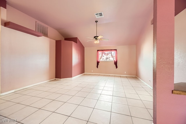 spare room with ceiling fan, light tile patterned flooring, and lofted ceiling