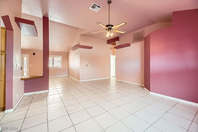 tiled empty room featuring ceiling fan and lofted ceiling