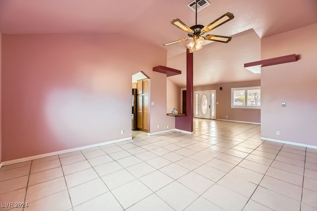 tiled spare room with vaulted ceiling and ceiling fan