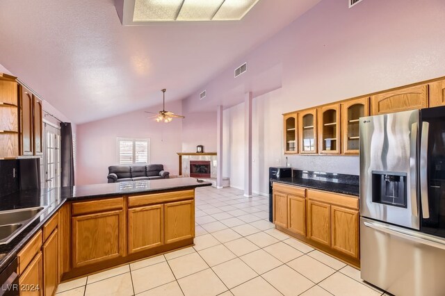 kitchen featuring stainless steel refrigerator with ice dispenser, light tile patterned floors, ceiling fan, and lofted ceiling