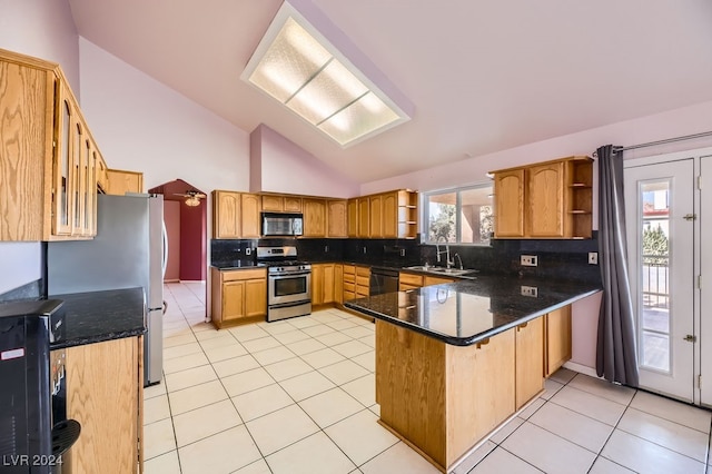 kitchen featuring kitchen peninsula, appliances with stainless steel finishes, decorative backsplash, sink, and light tile patterned floors