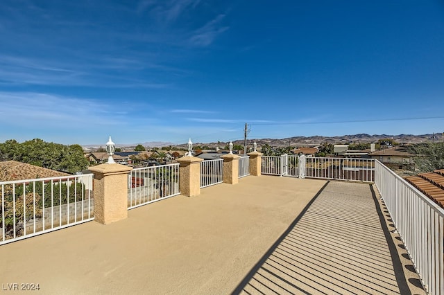 view of patio / terrace with a mountain view and a balcony