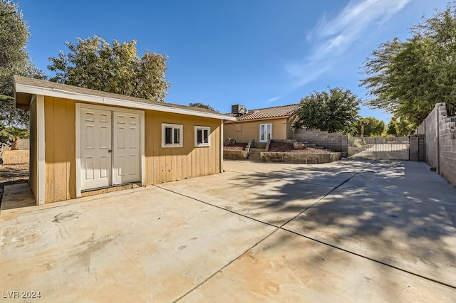 exterior space with an outdoor structure and a patio area