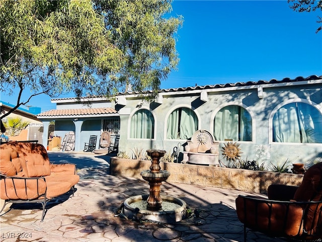 rear view of property with a patio area