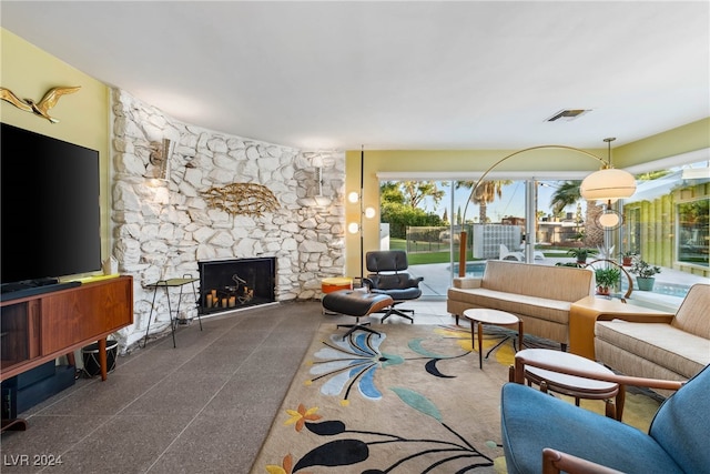 living room with a stone fireplace