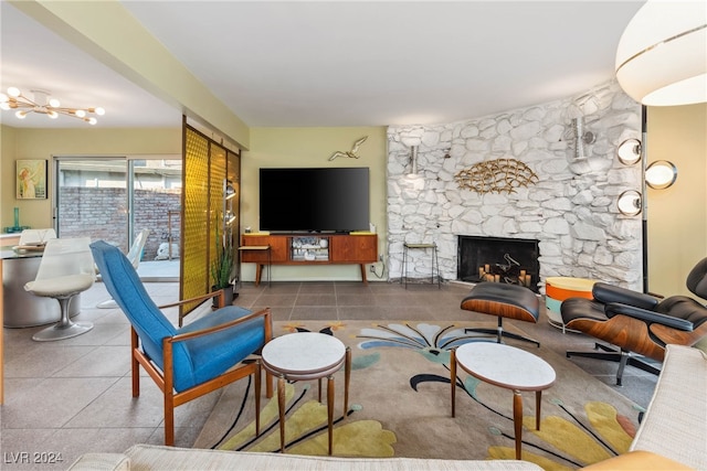 living room featuring tile patterned flooring and a stone fireplace