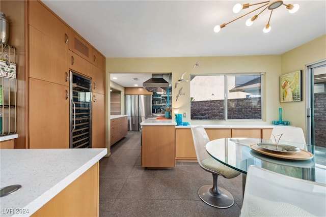 kitchen featuring stainless steel fridge, beverage cooler, and an inviting chandelier