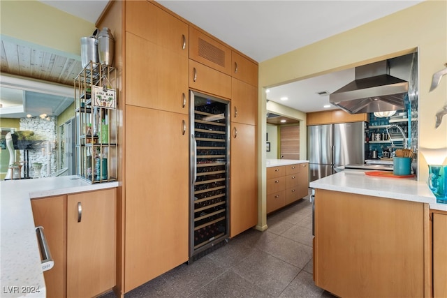 kitchen featuring wine cooler, exhaust hood, and stainless steel refrigerator