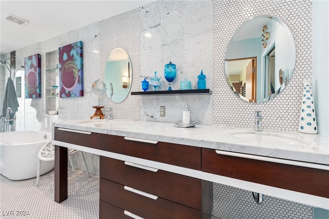 bathroom featuring vanity, a bathtub, tile walls, and decorative backsplash