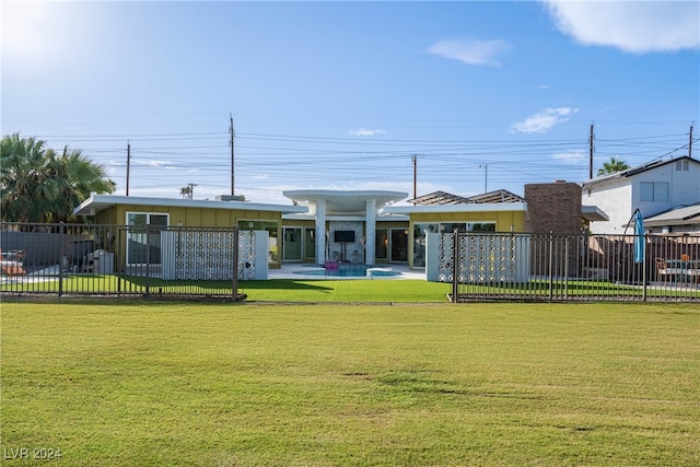 rear view of house featuring a lawn