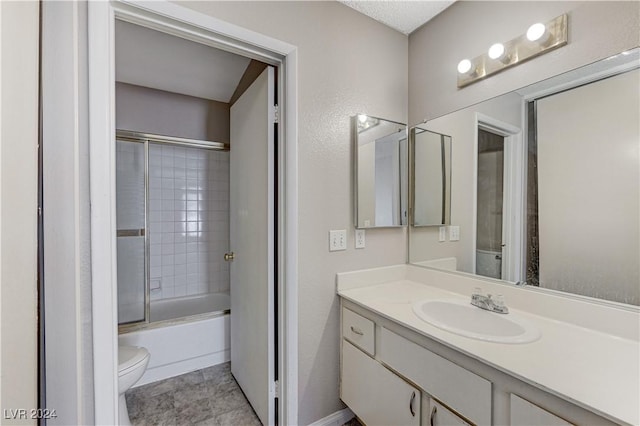 full bathroom with toilet, vanity, shower / bath combination with glass door, and tile patterned flooring