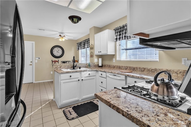 kitchen with white cabinets, white dishwasher, refrigerator, sink, and a healthy amount of sunlight