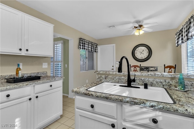 kitchen featuring ceiling fan, sink, white cabinets, and light stone countertops