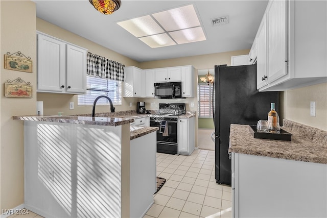 kitchen with black appliances, light stone counters, white cabinetry, and light tile patterned floors