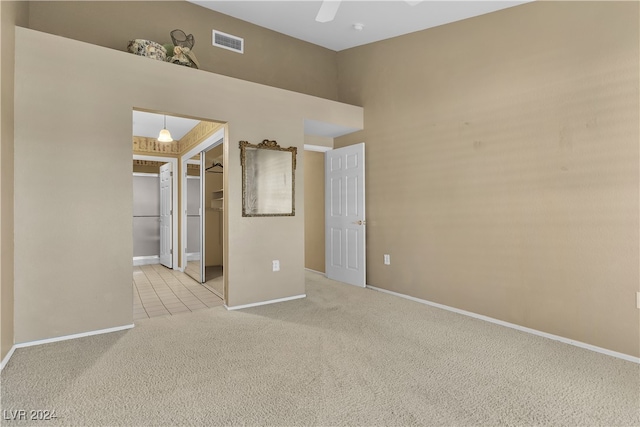 carpeted spare room with ceiling fan