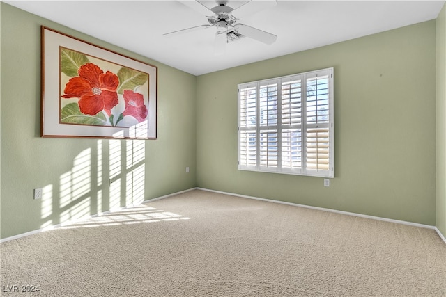 empty room featuring carpet floors and ceiling fan