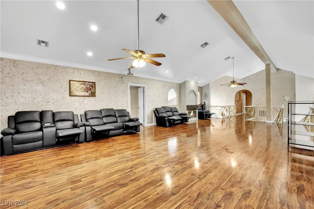 living room featuring light hardwood / wood-style floors, crown molding, lofted ceiling, and ceiling fan