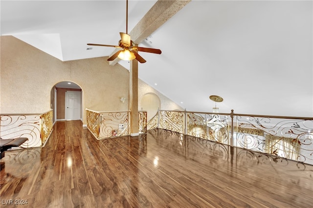 unfurnished living room featuring ceiling fan, hardwood / wood-style flooring, and vaulted ceiling with beams