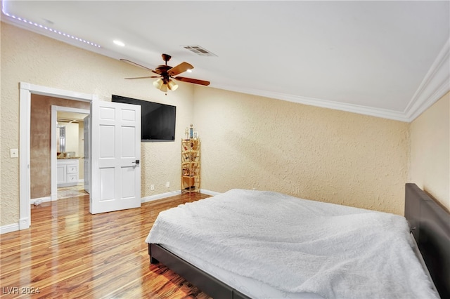 bedroom with crown molding, wood-type flooring, and ceiling fan