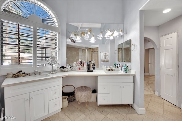 bathroom with a shower with door and vanity