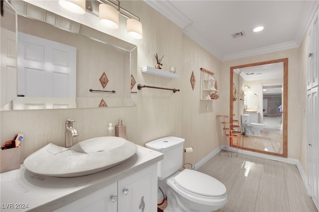 bathroom featuring vanity, toilet, and crown molding