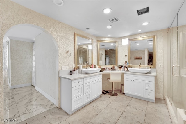 bathroom featuring vanity and an enclosed shower