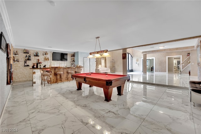 game room featuring pool table, ornamental molding, and bar