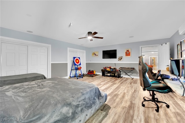 bedroom with hardwood / wood-style flooring, a closet, and ceiling fan