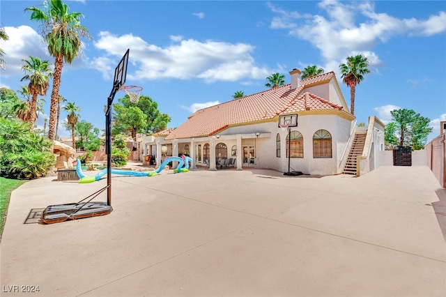 back of house featuring a patio, french doors, and a swimming pool