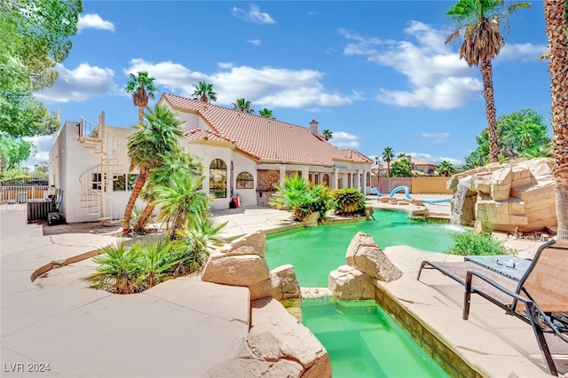 view of swimming pool with a patio and pool water feature