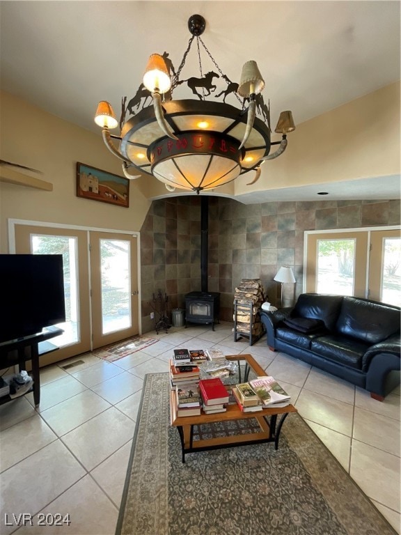 291E Madison Ave, Ely, NV 89301 - living room with tile patterned flooring, a wood stove, a chandelier, and lofted ceiling