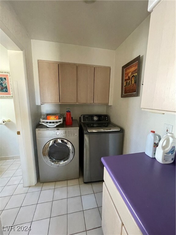 291E Madison Ave, Ely, NV 89301 - washroom with cabinet space, washing machine and dryer, and light tile patterned floors