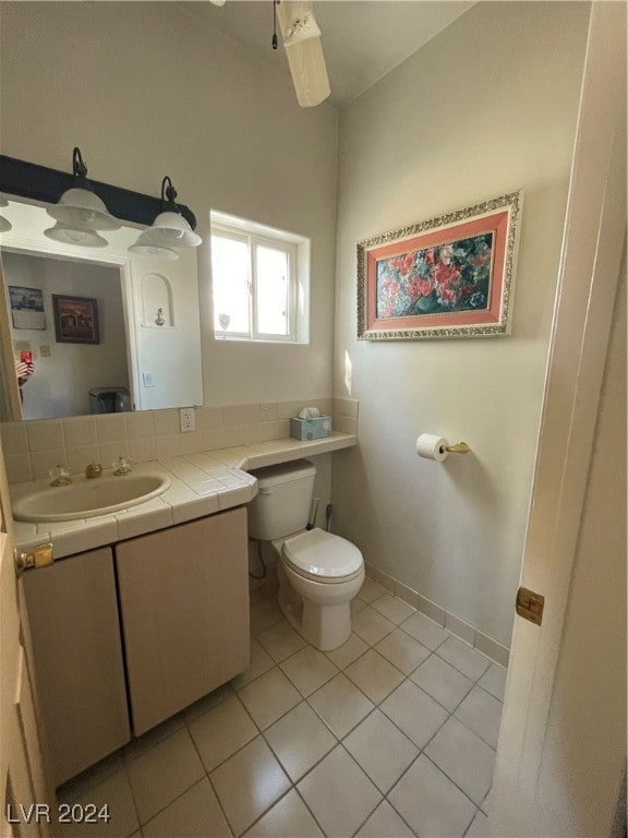 291E Madison Ave, Ely, NV 89301 - half bath featuring toilet, tile patterned flooring, vanity, and baseboards