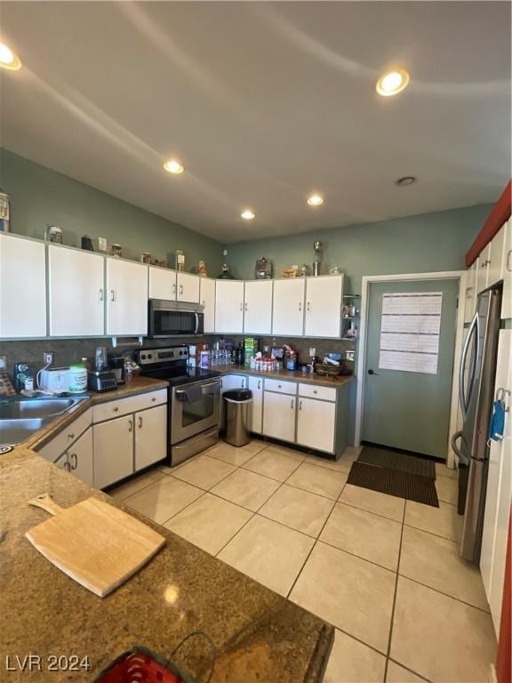 291E Madison Ave, Ely, NV 89301 - kitchen featuring appliances with stainless steel finishes, a sink, white cabinetry, tasteful backsplash, and light tile patterned flooring