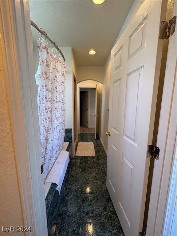 291E Madison Ave, Ely, NV 89301 - hallway featuring arched walkways, recessed lighting, and dark marble finish flooring