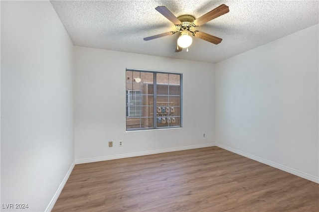 spare room with ceiling fan, hardwood / wood-style floors, and a textured ceiling