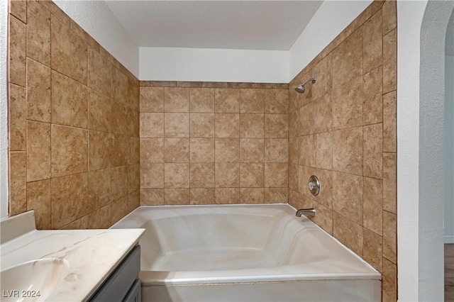 bathroom with vanity and tiled shower / bath