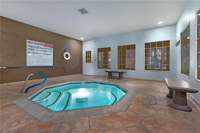 view of pool with an indoor hot tub