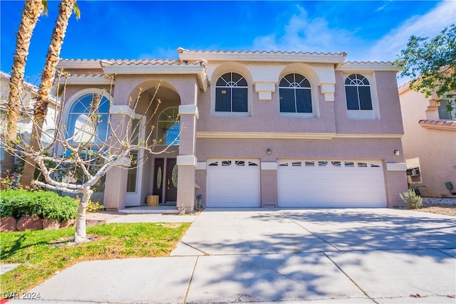 mediterranean / spanish-style house featuring a garage