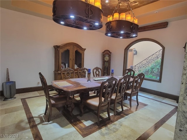 dining room with arched walkways and baseboards