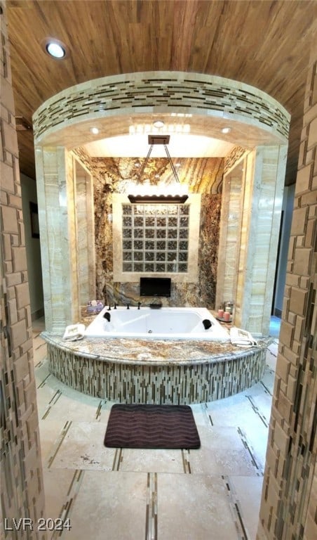 bathroom with wooden ceiling and a whirlpool tub