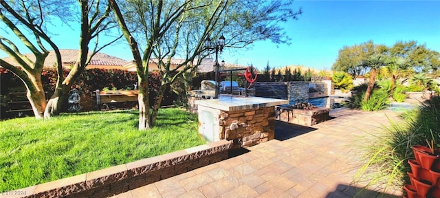 view of patio / terrace featuring exterior kitchen and fence