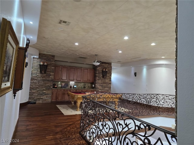 hallway featuring dark wood finished floors, visible vents, and recessed lighting