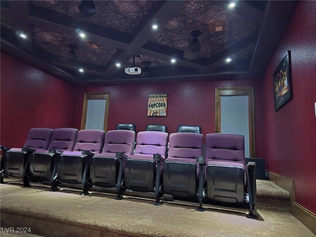 carpeted cinema room featuring beam ceiling, baseboards, and coffered ceiling