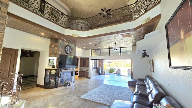 living room with visible vents, baseboards, and a high ceiling