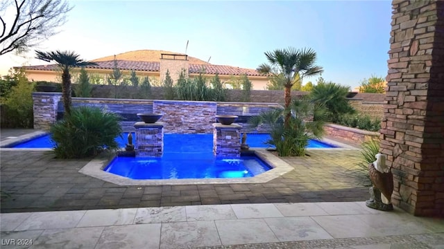 view of pool featuring a patio area and a fenced backyard