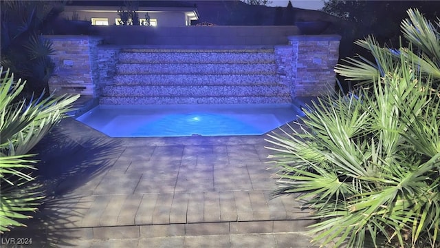 view of pool with a jacuzzi and a patio