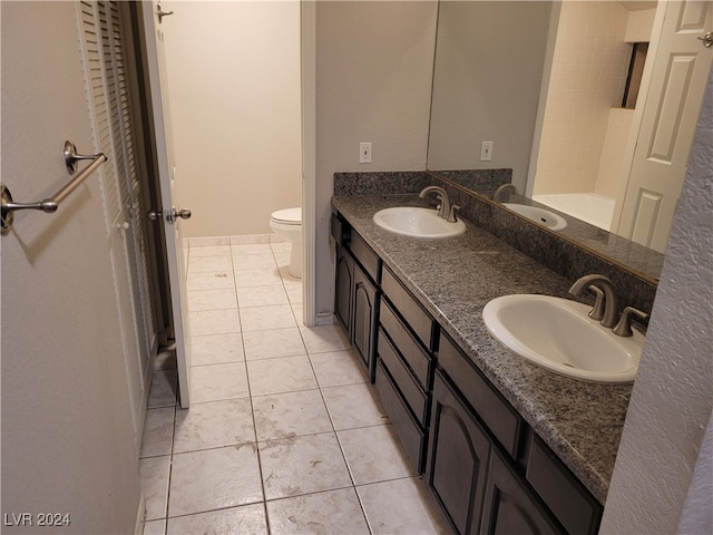 bathroom featuring tile patterned flooring, vanity, and toilet