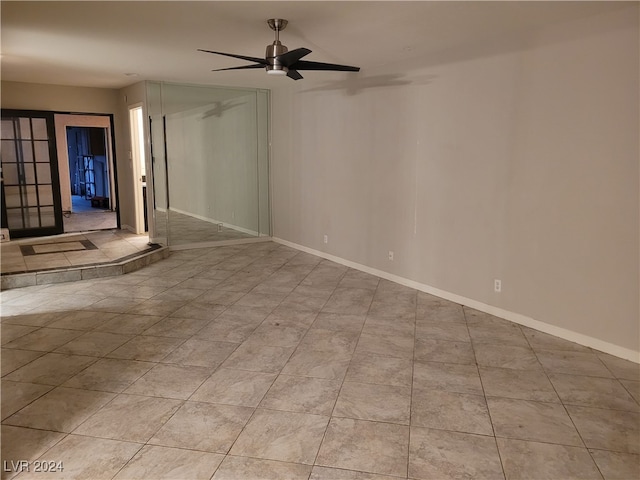 unfurnished room with ceiling fan and light tile patterned flooring