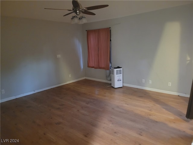 empty room with ceiling fan and light hardwood / wood-style floors